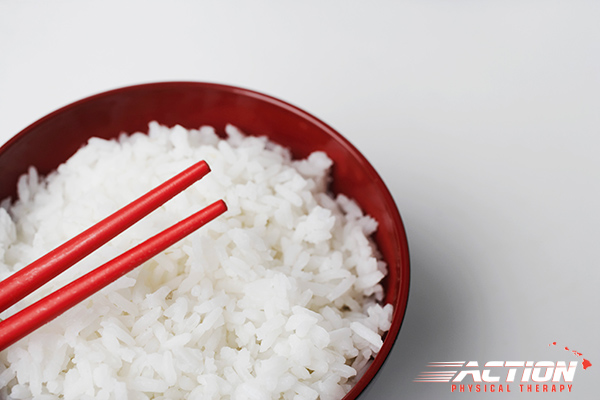 Bowl of white rice with chopsticks