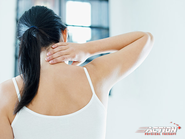 Woman touching her painful neck.